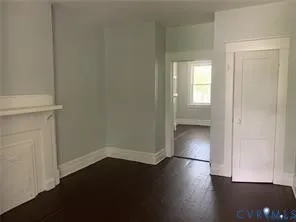 an empty room with wooden floor