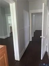 a view of a closet and wooden floor