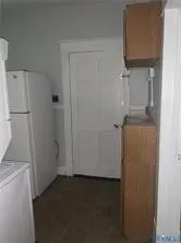a white refrigerator freezer and a stove sitting inside of a kitchen