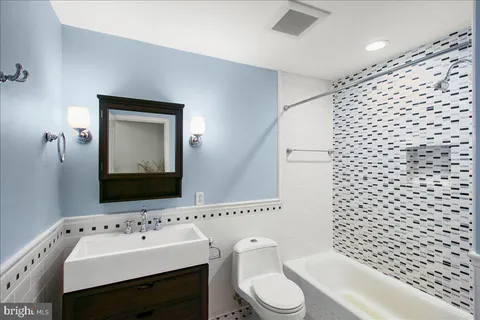 a bathroom with a sink toilet and mirror