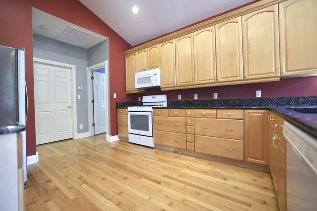a view of a kitchen with granite countertop cabinets and a sink