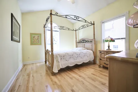 a bedroom with a bed window and a table