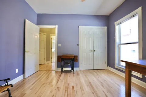 a view of empty room with a window and wooden floor