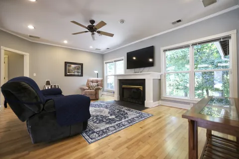 a living room with furniture a flat screen tv and a fireplace
