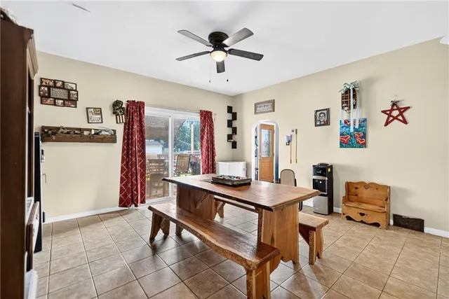a room with furniture a rug and a ceiling fan