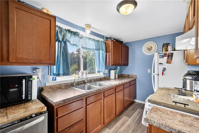 a kitchen with a sink stove and refrigerator