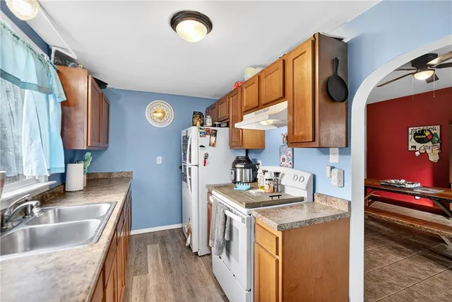 a kitchen with a sink stove and cabinets