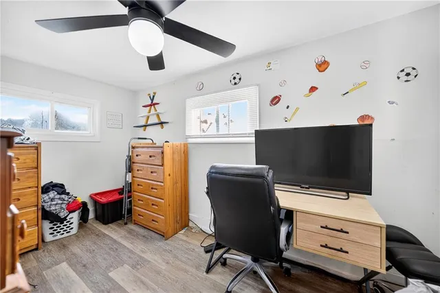 a bedroom with bed and wooden floor