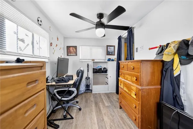 a bed room with a bed window and a chandelier