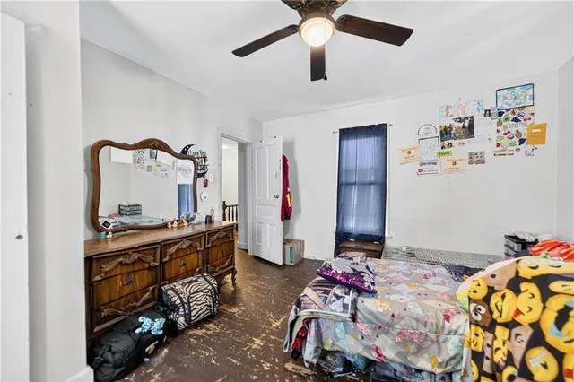 a view of a house with backyard and wooden fence