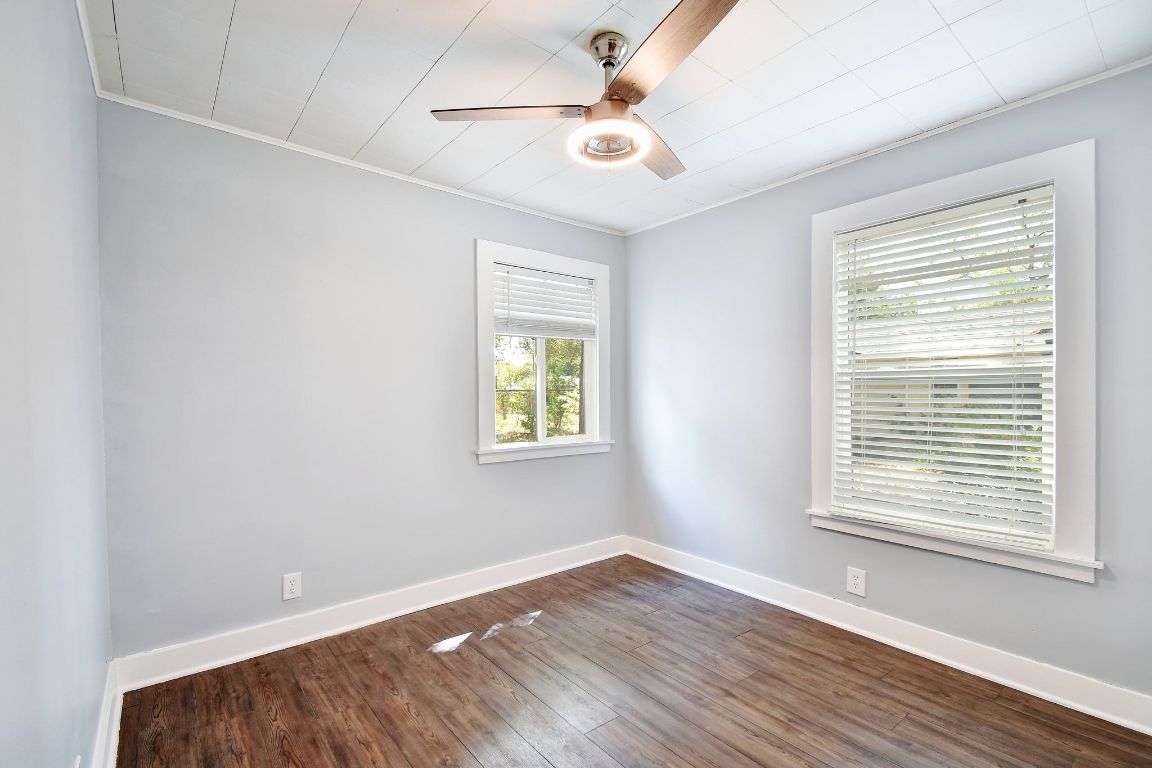 717 South Laurel Avenue Luling, TX 78648 - Photo 13 of 34 a view of an empty room with wooden floor and a window