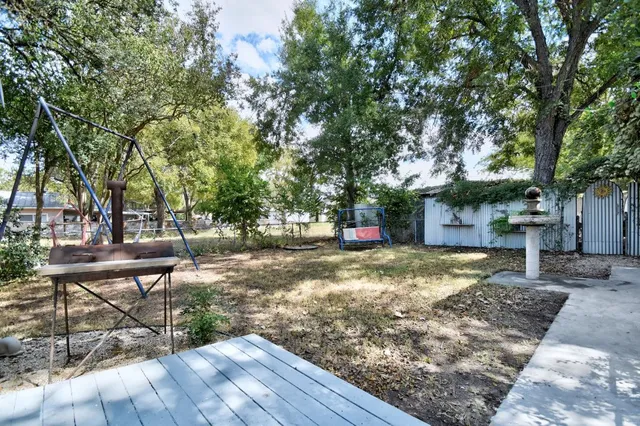 a backyard of a house with table and chairs