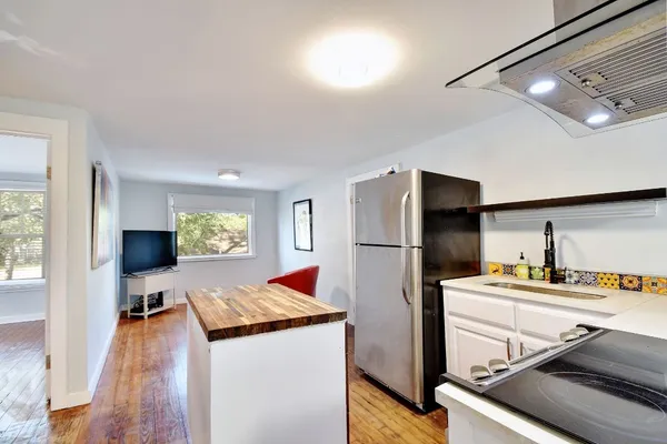 a kitchen with sink refrigerator and microwave
