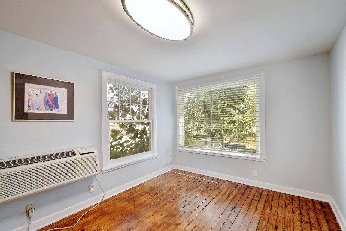 717 South Laurel Avenue Luling, TX 78648 - Photo 27 of 34 a view of an empty room with window and wooden floor