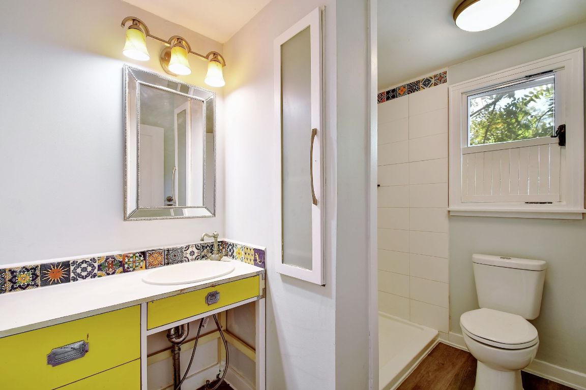 717 South Laurel Avenue Luling, TX 78648 - Photo 31 of 34 a bathroom with a sink a toilet and a mirror