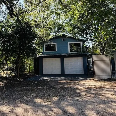 a house that has a tree in front of it