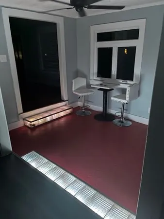 a view of workspace with mirror wall and window