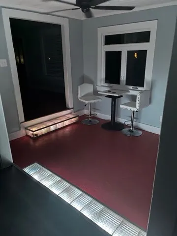 a view of workspace with mirror wall and window