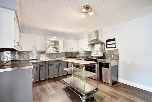 a kitchen with stainless steel appliances granite countertop a stove and a refrigerator