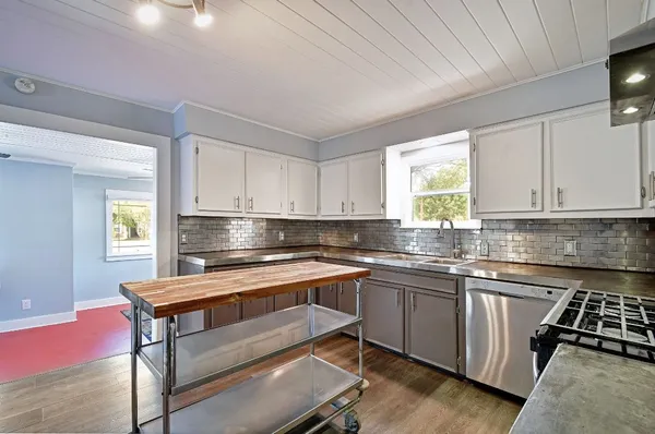 a kitchen with a stove a sink and a microwave