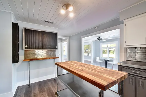 a room with pool table and windows