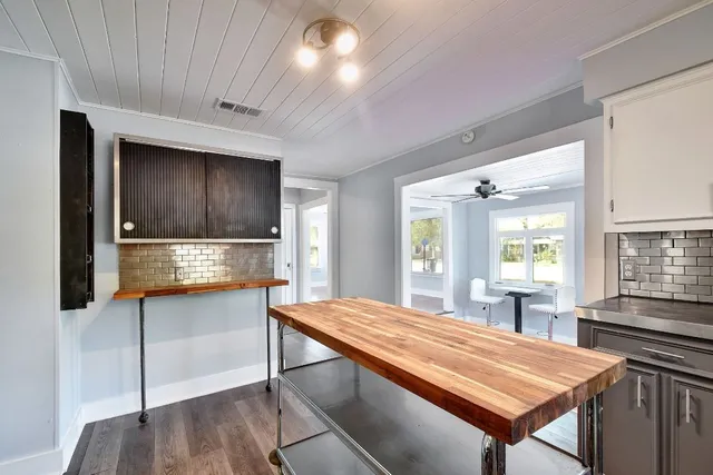 a room with pool table and windows
