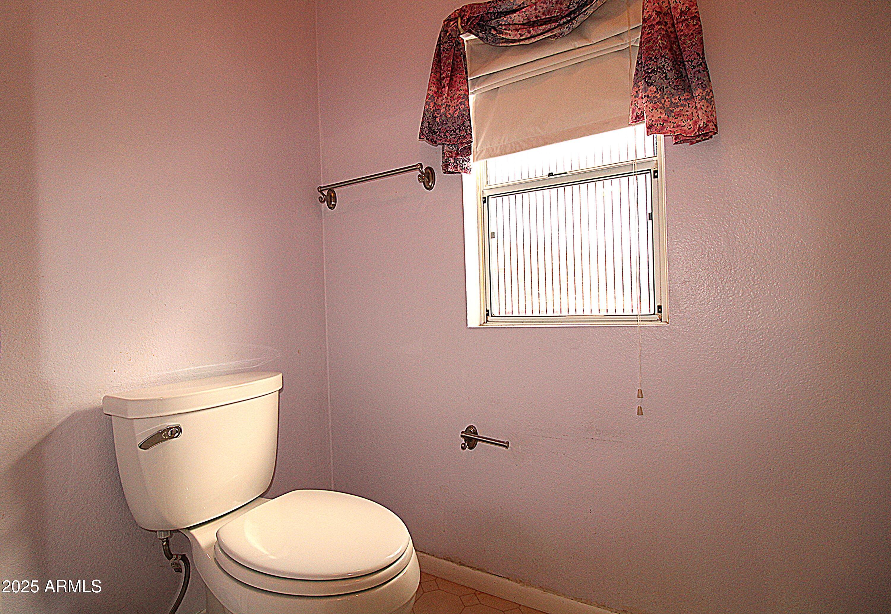 2400 East Baseline Avenue, Unit 232 Apache Junction, AZ 85119 - Photo 22 of 37 a white toilet sitting next to a window