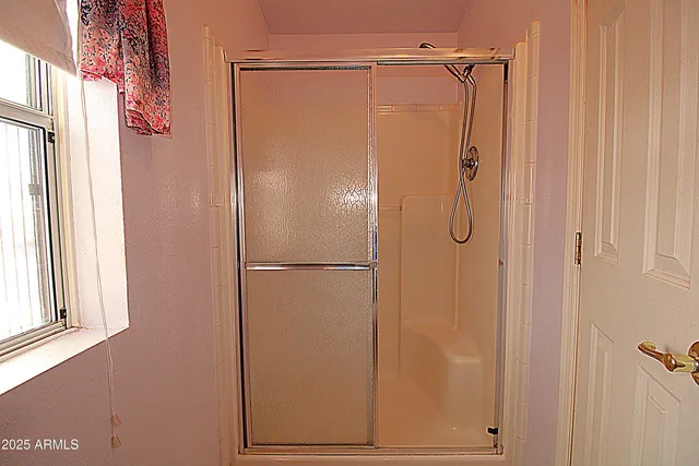 a bathroom with a glass shower door