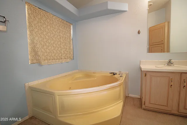 a bathroom with a bathtub and a window