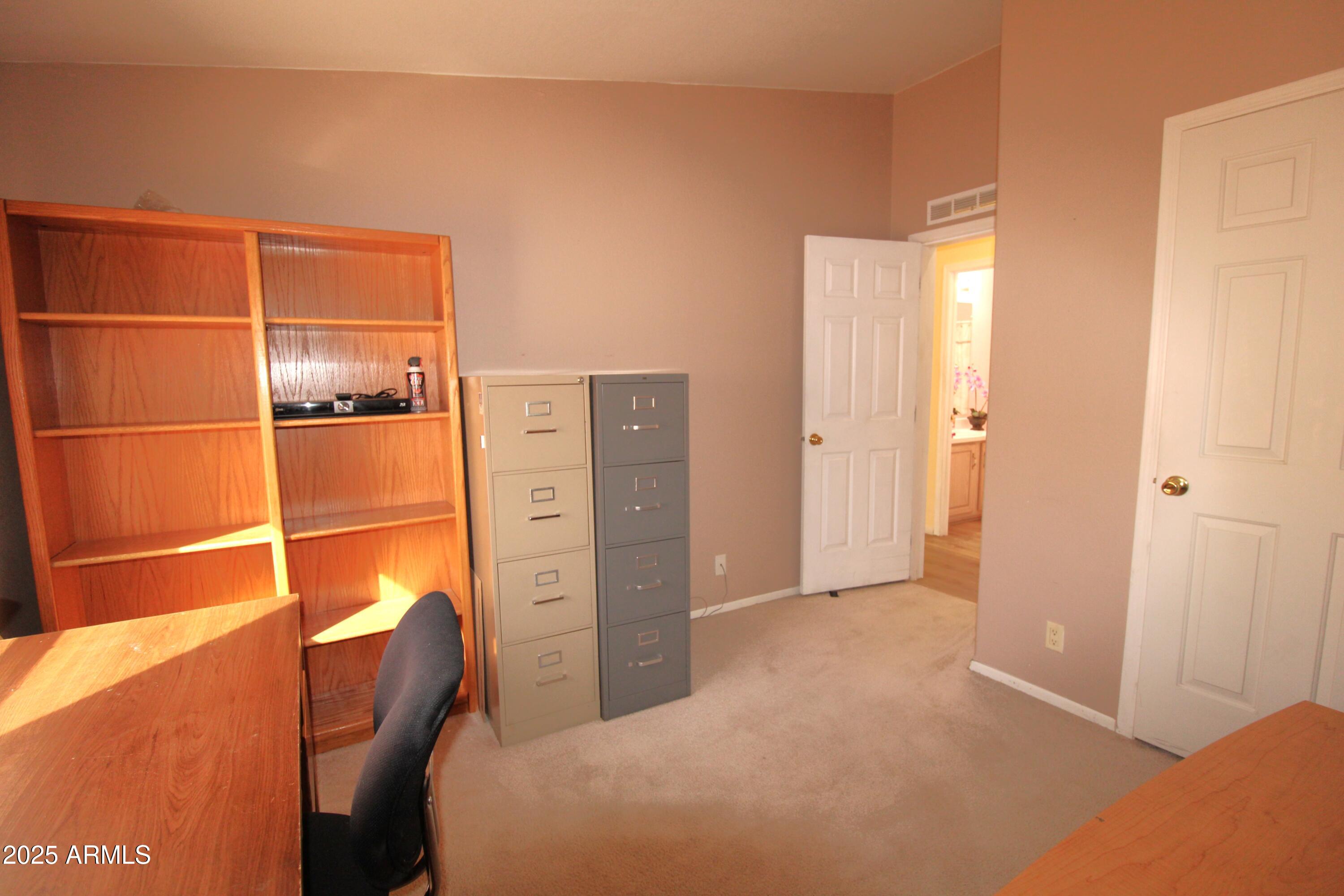 2400 East Baseline Avenue, Unit 232 Apache Junction, AZ 85119 - Photo 27 of 37 a bedroom with a bed and cabinets