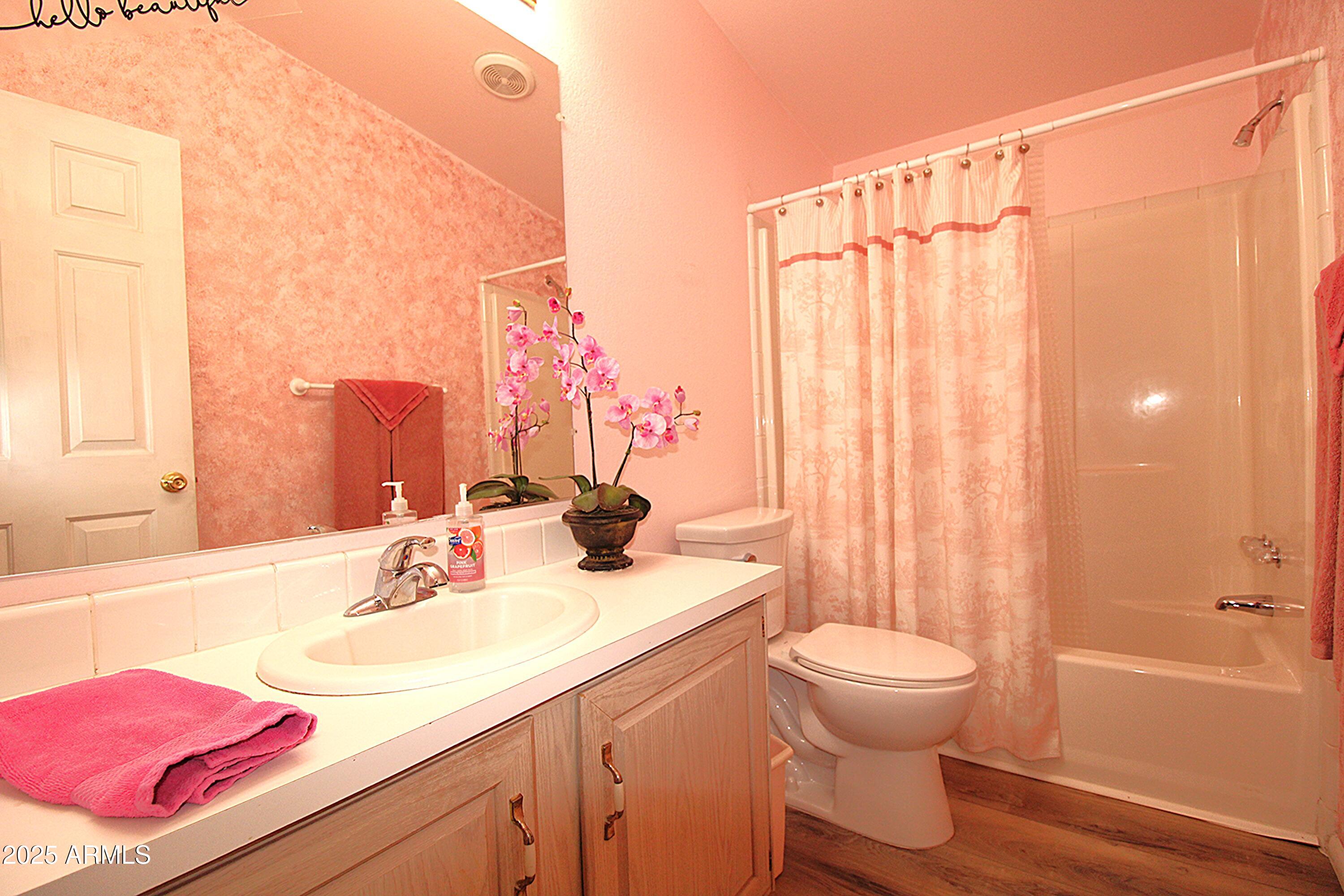 2400 East Baseline Avenue, Unit 232 Apache Junction, AZ 85119 - Photo 28 of 37 a bathroom with a sink a toilet and shower curtain