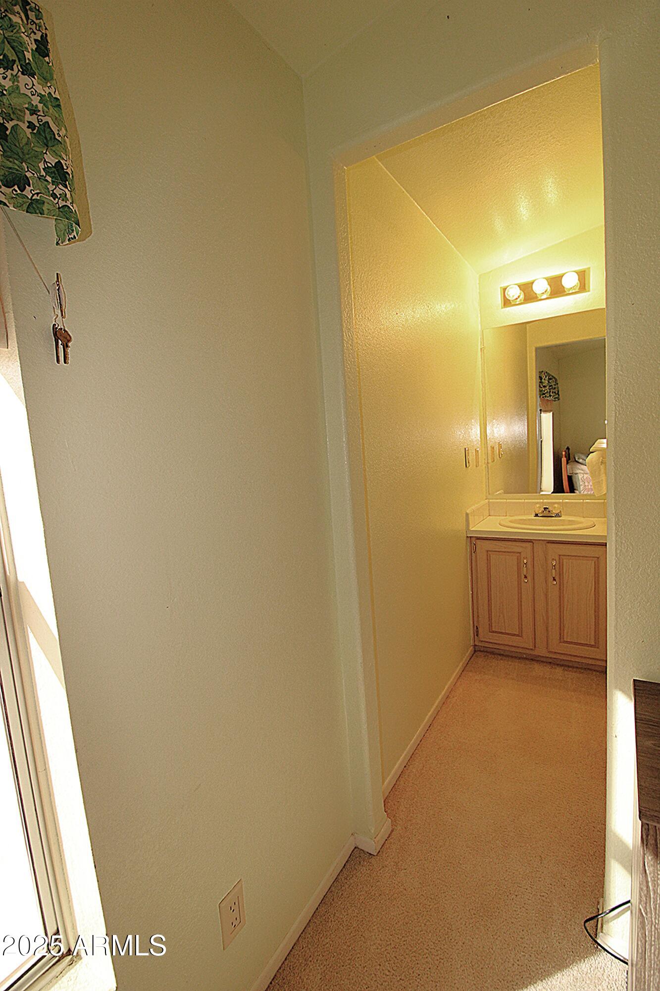 2400 East Baseline Avenue, Unit 232 Apache Junction, AZ 85119 - Photo 30 of 37 a bathroom with a sink and a mirror