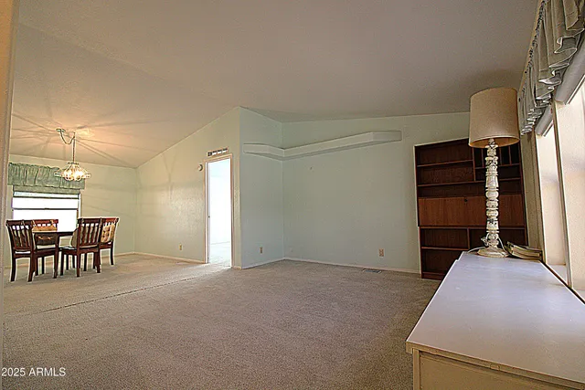 a view of a livingroom with furniture and a window