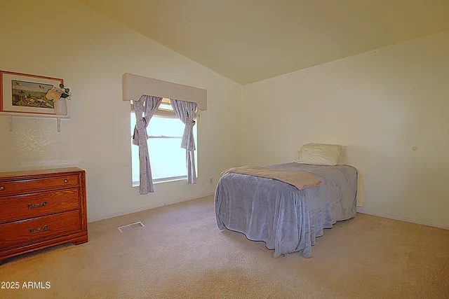 a room with a bed and window