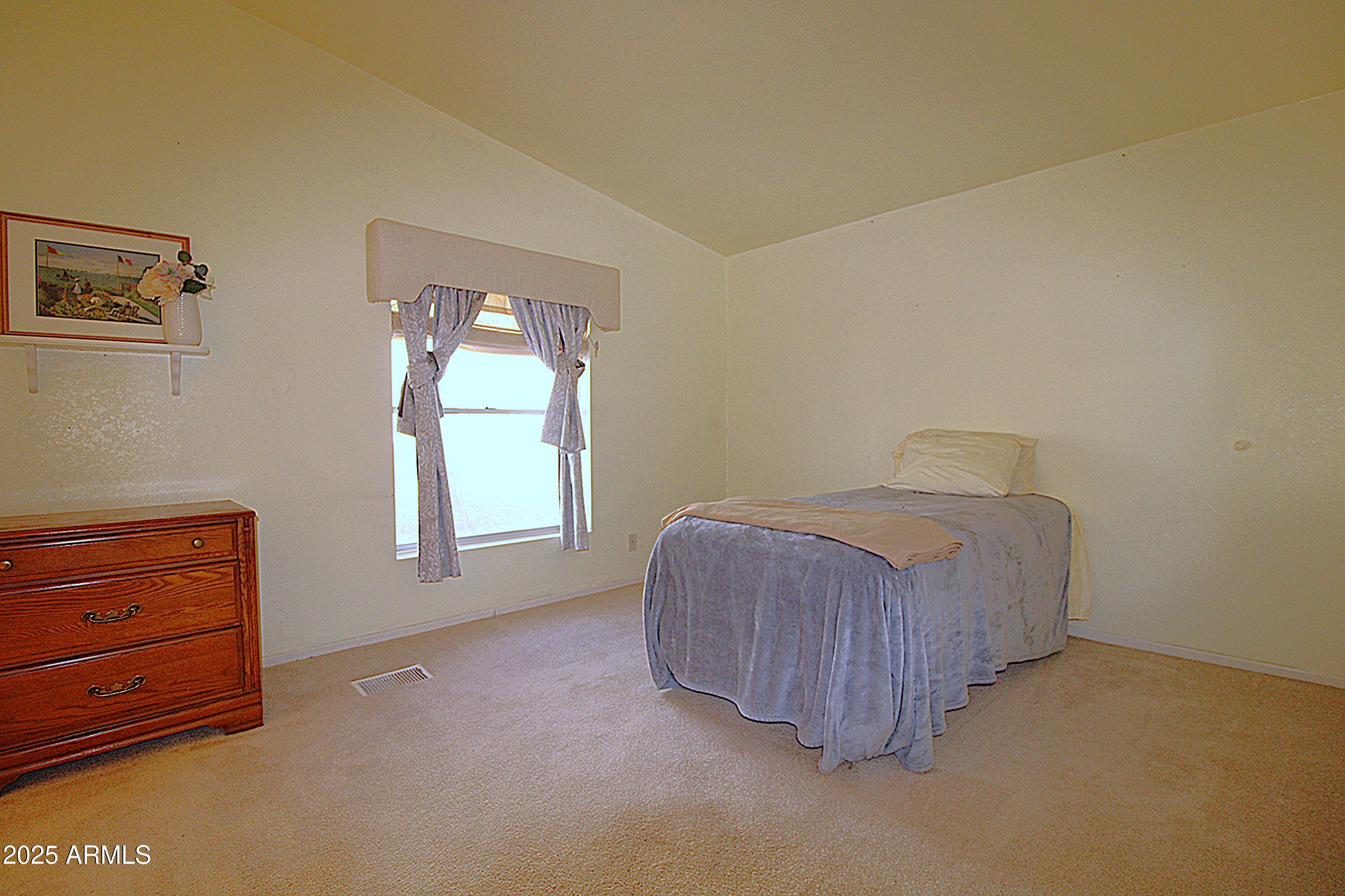 2400 East Baseline Avenue, Unit 232 Apache Junction, AZ 85119 - Photo 34 of 37 a room with a bed and window