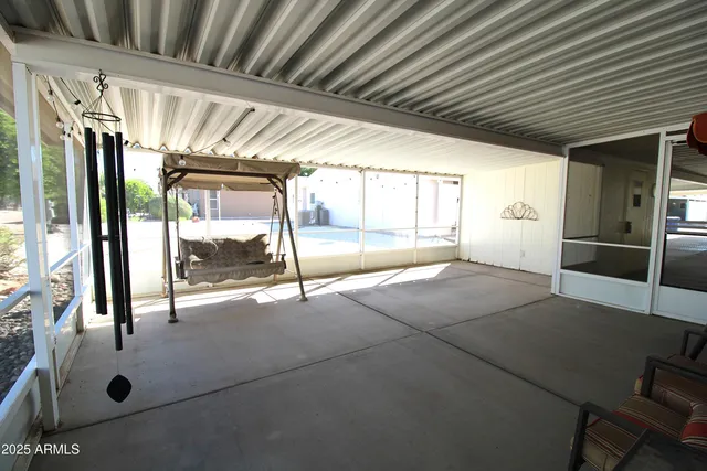 a view of empty room with wooden floor and floor to ceiling window