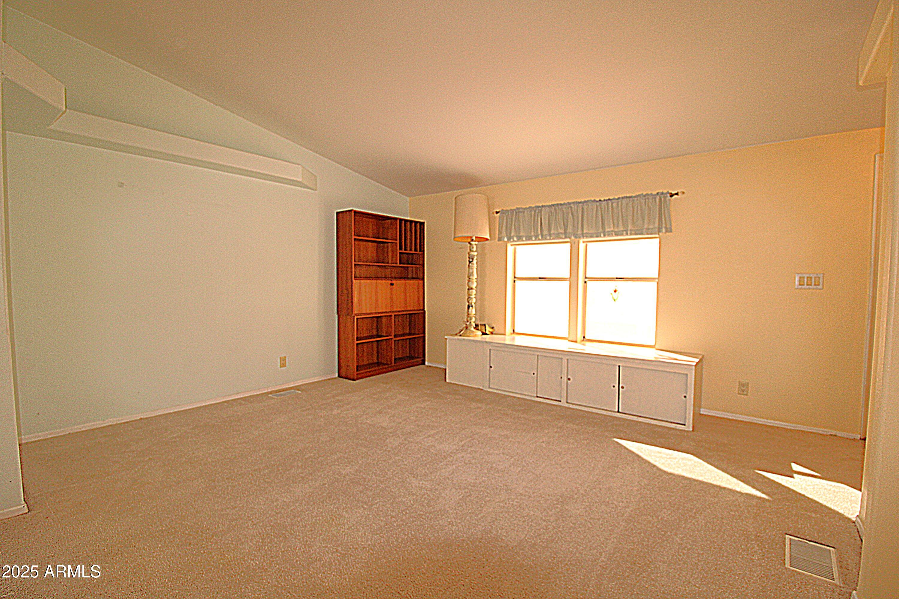 2400 East Baseline Avenue, Unit 232 Apache Junction, AZ 85119 - Photo 4 of 37 an empty room with windows