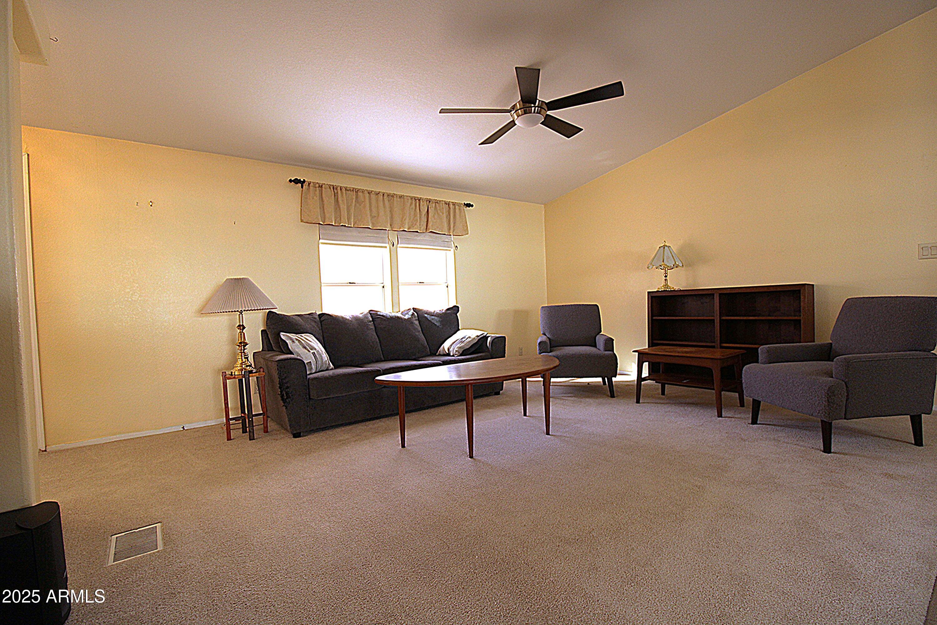 2400 East Baseline Avenue, Unit 232 Apache Junction, AZ 85119 - Photo 5 of 37 a living room with furniture and a flat screen tv
