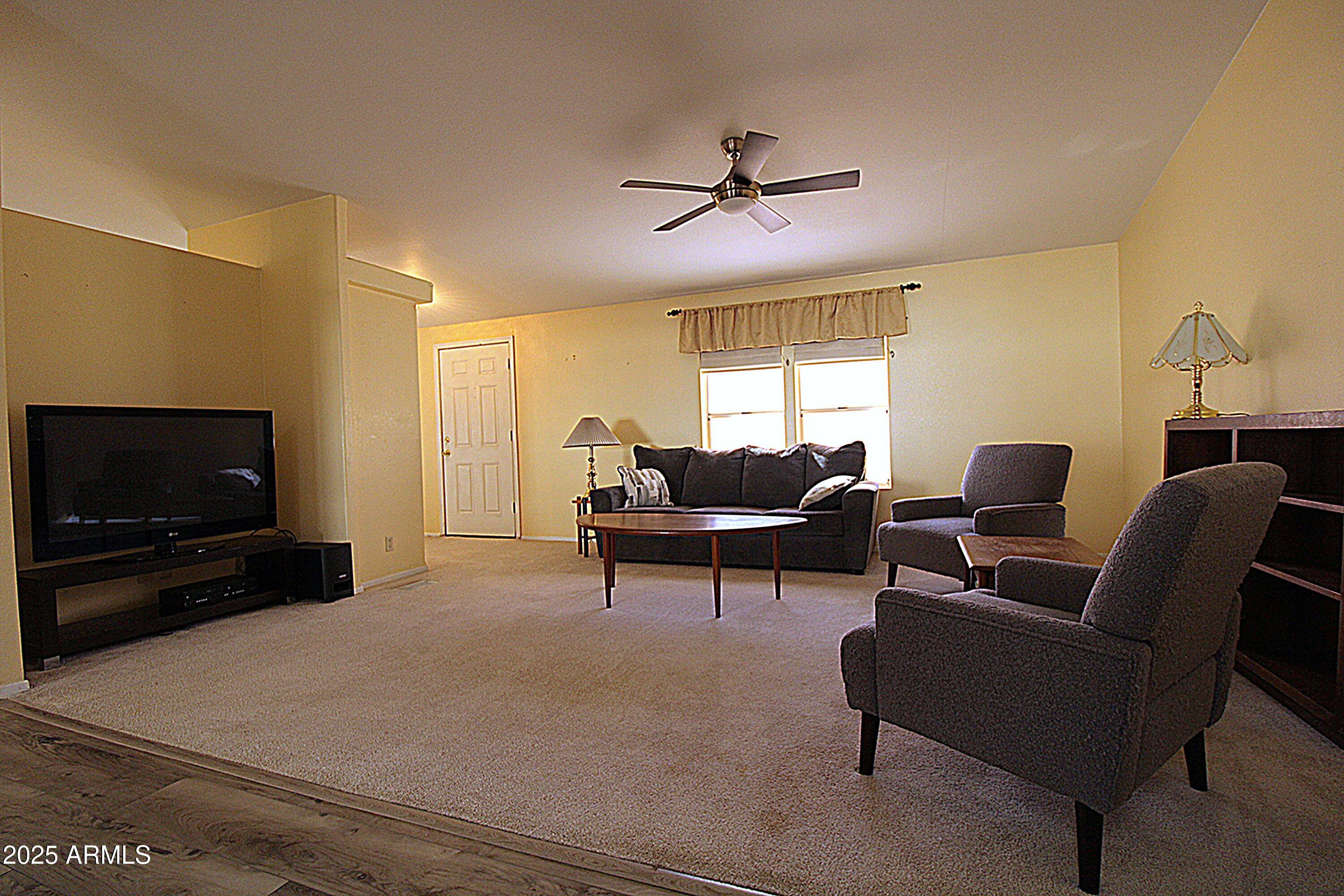 2400 East Baseline Avenue, Unit 232 Apache Junction, AZ 85119 - Photo 6 of 37 a living room with furniture and a flat screen tv