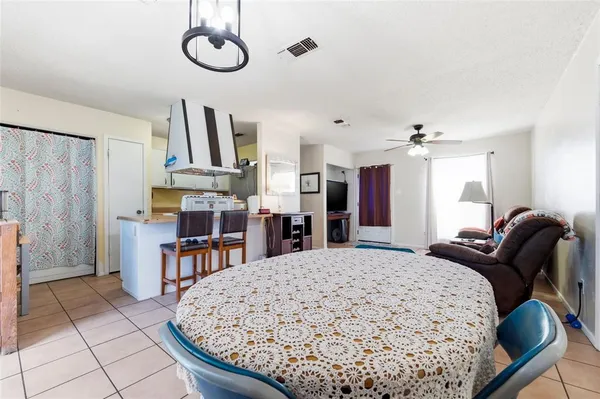 a living room with furniture and kitchen area