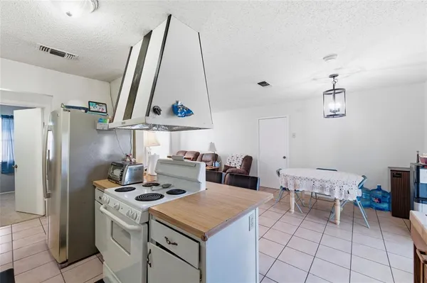 a kitchen with a stove a sink and a refrigerator