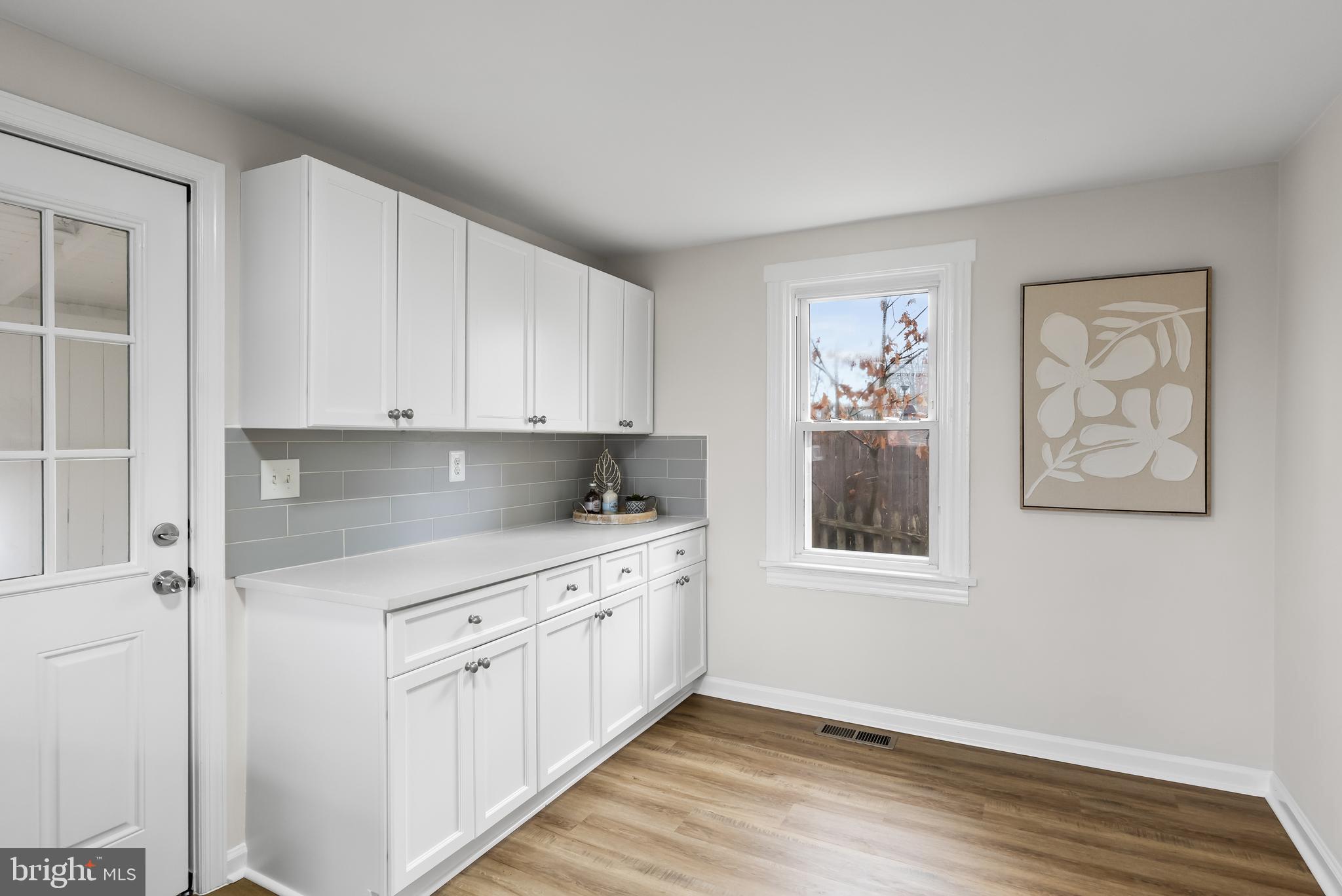 154 Kings Highway Mount Royal, NJ 08061 - Photo 24 of 45 a kitchen with white cabinets and wooden floor