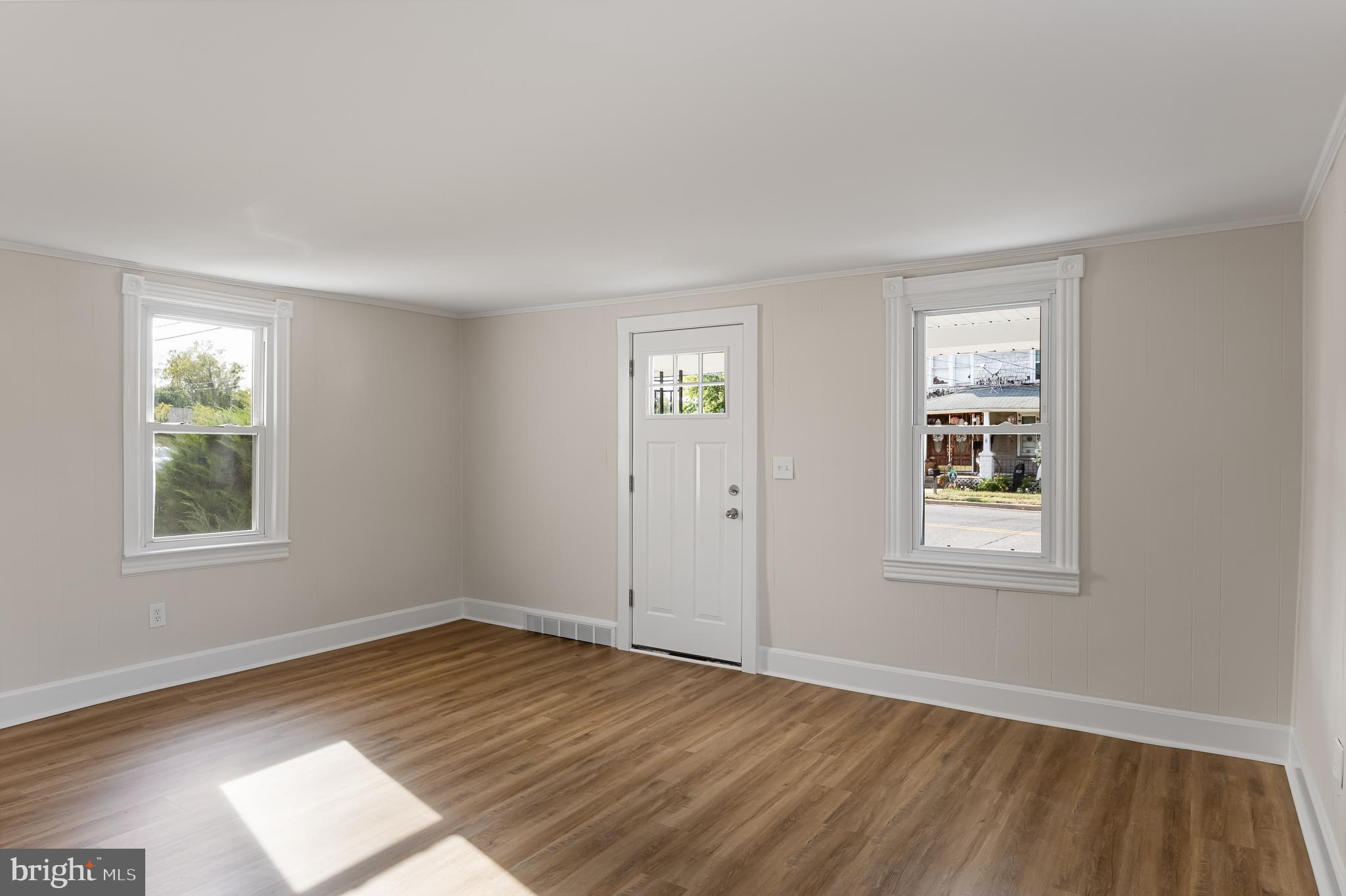 154 Kings Highway Mount Royal, NJ 08061 - Photo 5 of 45 a view of an empty room with wooden floor and a window