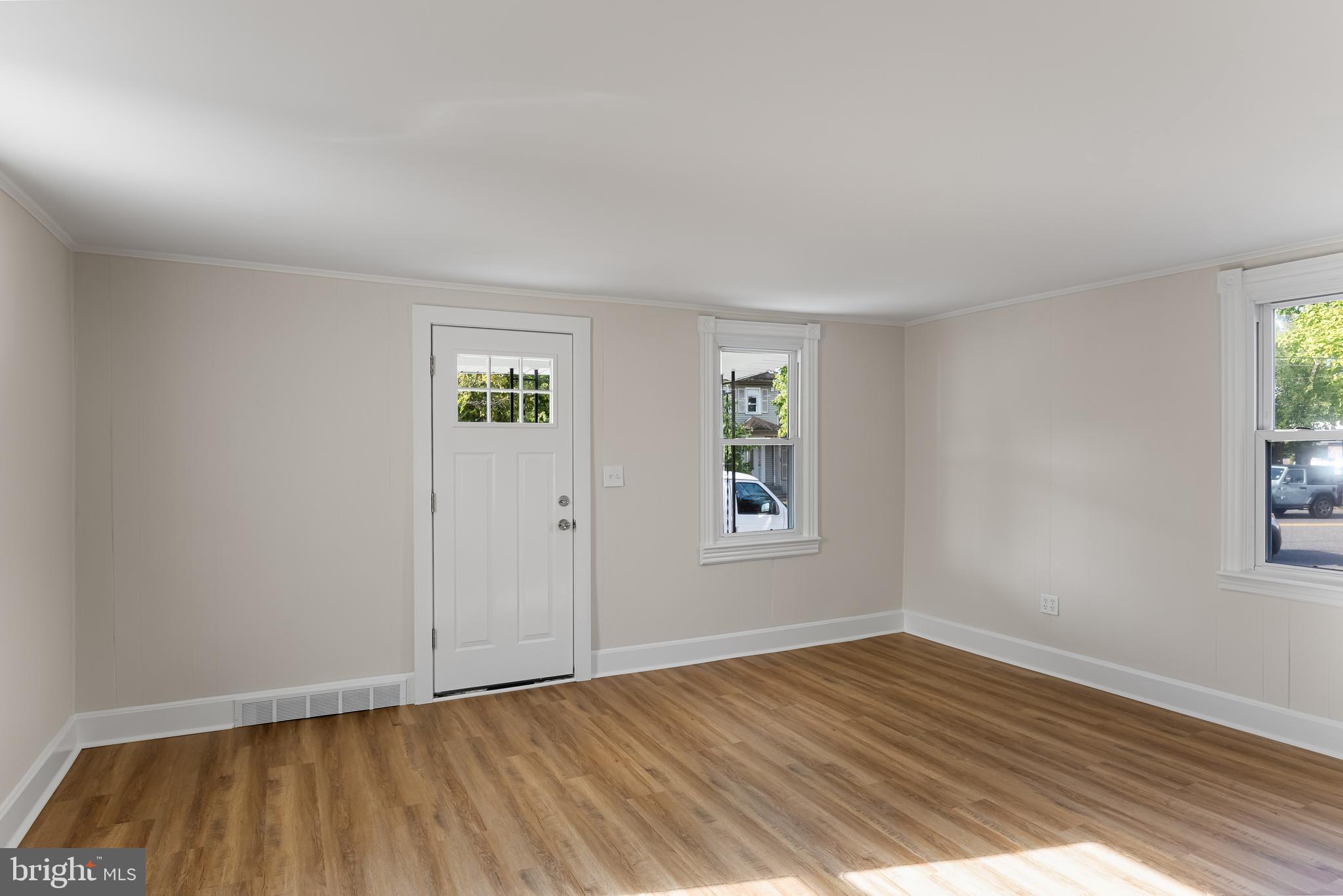 154 Kings Highway Mount Royal, NJ 08061 - Photo 7 of 45 a view of an empty room with wooden floor and a window
