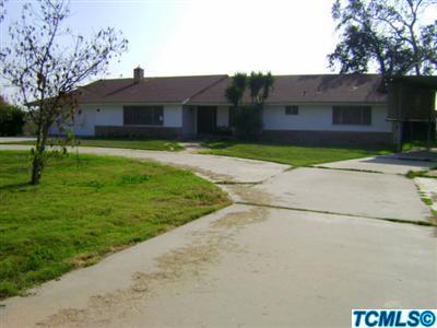 2193 West Visalia Road Exeter, CA 93221 - Photo 1 of 23 a front view of a house with a garden and yard