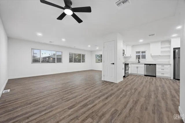 a view of wooden floor and windows in a room