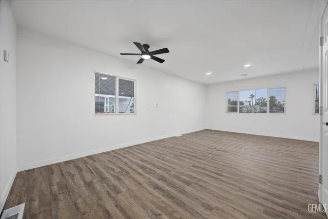 a view of a hallway with wooden floor and entryway