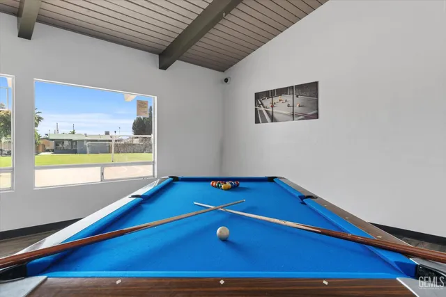 a view of a patio with table and chairs under an umbrella