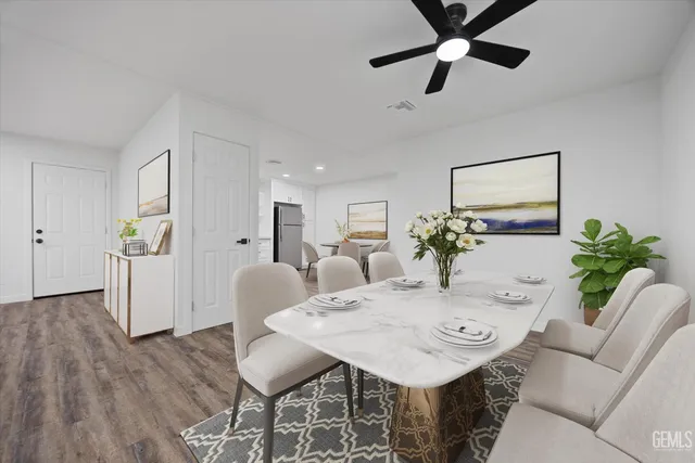 a kitchen with a refrigerator a stove top oven and wooden floor
