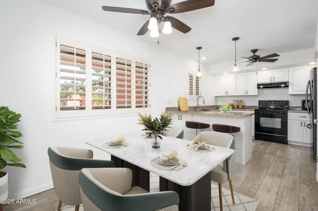 a living room with stainless steel appliances kitchen island granite countertop furniture and a kitchen view
